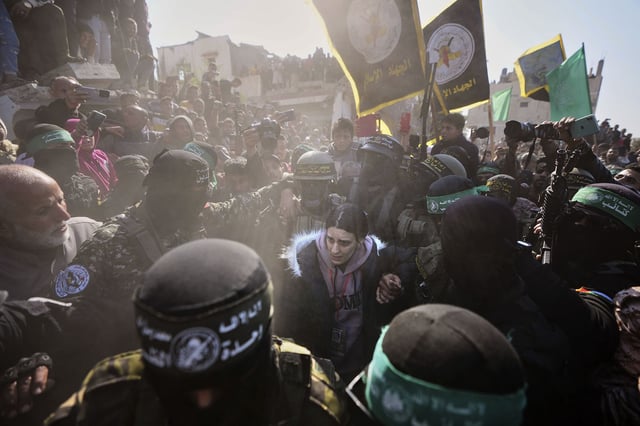Arbel Yehoud is escorted by Hamas and Islamic Jihad militants in Khan Younis, Gaza, on Thursday.