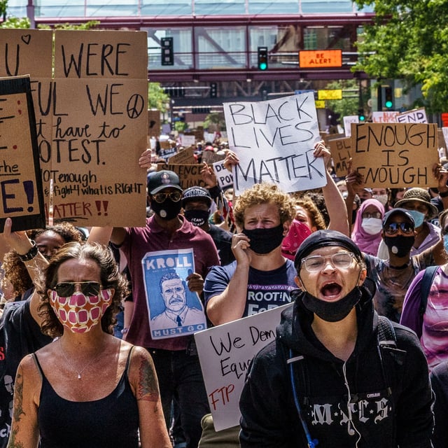 Protesters march near the Minneapolis 1st Police precinct during a demonstration against police brutality and racism on June 13, 2020 in Minneapolis, Minnesota.