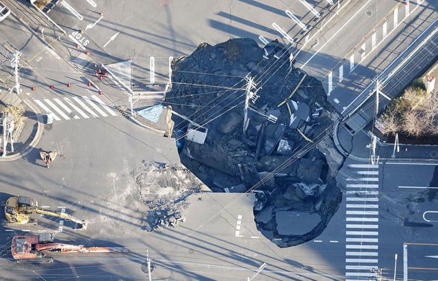 An aerial view of a large sinkhole that swallowed a truck and a man at an intersection in Yashio, Saitama Prefecture on January 30, 2025.