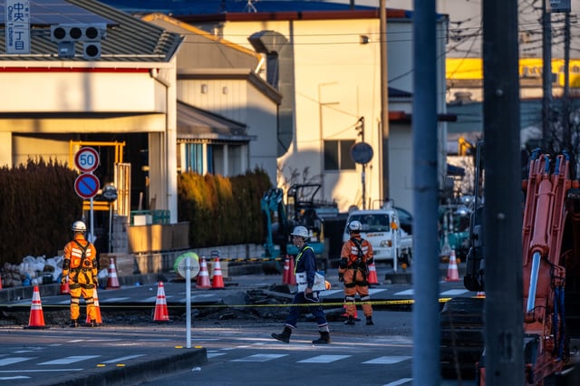 Rescue operations continue for a truck driver after his vehicle plunged into a sinkhole in Yashio, Saitama Prefecture.