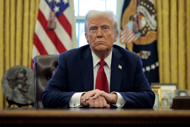U.S. President Donald Trump talks to reporters from the Resolute Desk after signing an executive order to appoint the deputy administrator of the Federal Aviation Administration in the Oval Office at the White House on January 30, 2025 in Washington, DC. Trump also signed a memorandum ordering an immediate assessment of aviation safety and ordering an elevation of what he called “competence” over “D.E.I.”