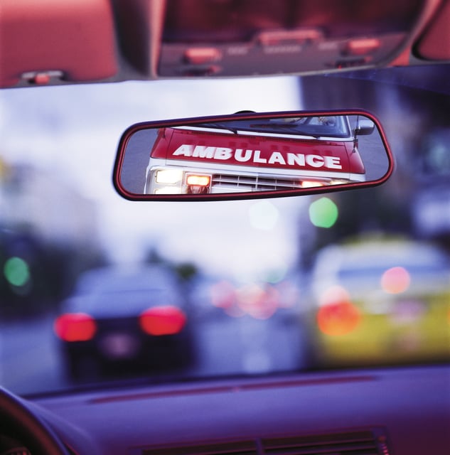 File photo of an ambulance seen a car&#39;s rearview mirror.