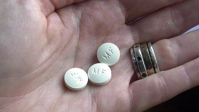 Three RU-486 Mifeprex abortion pills are held in a hand December 1, 2000 in Granite City, Illinois.