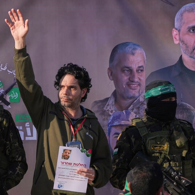 Israeli Ofer Kalderon who has been held hostage by Hamas in Gaza since October 7, 2023, waves before being handed over to the Red Cross by Hamas fighters in Khan Younis, southern Gaza Strip, Saturday Feb. 1, 2025. Photo/Abdel Kareem)