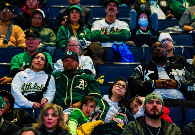 Oakland A’s fans watch a tribute during Oakland A’s great Rickey Henderson’s Celebration of Life Ceremony at Oakland Arena on Saturday.