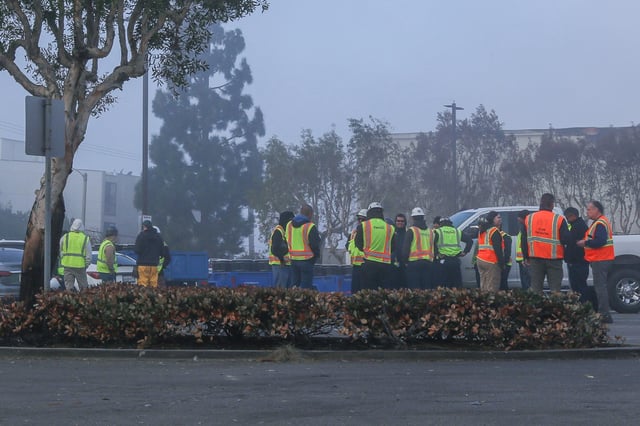 Contract workers assemble in a parking lot in Pacific Palisades before beginning work Sunday morning. (Photo by Jarret Liotta)