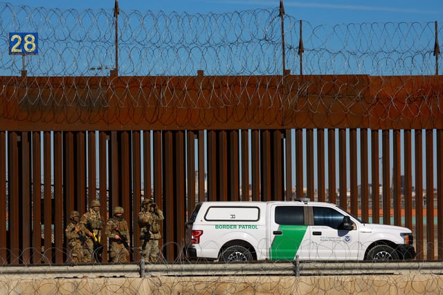 Members of the Texas National Guard stand guard near the border wall between Mexico and the United States, as seen from Ciudad Juarez, Mexico, January  14, 2025. REUTERS/Jose Luis Gonzalez/File Photo