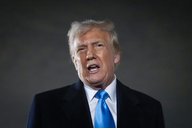 President Donald Trump speaks to reporters next to Air Force One after arriving back at Joint Base Andrews, Md., Sunday, Feb. 2, 2025.