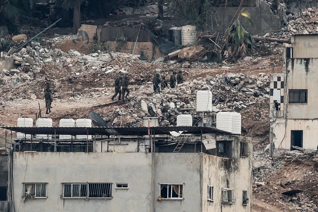 Israeli military members walk during an Israeli army operation in Jenin, in the Israeli-occupied West Bank, February 3, 2025.