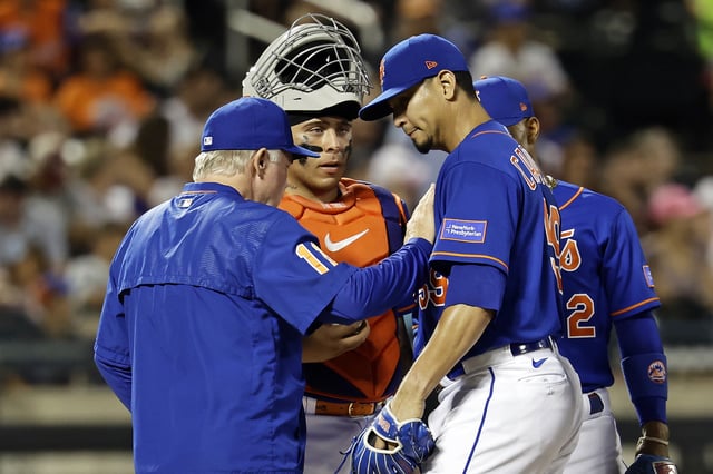 Carlos Carrasco (R) #59 of the New York Mets reacts as he is taken out of the game by Buck Showalter (L) #11 of the New York Mets during the third inning against the Washington Nationals at Citi Field on July 29, 2023 in New York City.