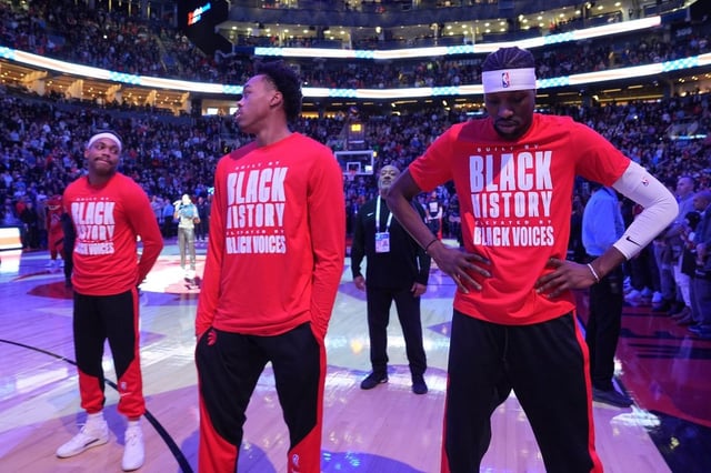 Toronto Raptors forward Bruce Brown, left to right, forward Scottie Barnes and forward Chris Boucher react as fans boo the American national anthem before first half NBA action against the LA Clippers in Toronto on Sunday, Feb. 2, 2025. THE CANADIAN PRESS/Frank Gunn