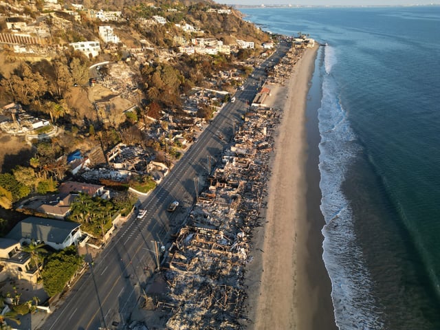 This aerial picture shows the remains of oceanfront homes destroyed in the Palisades Fire along the Pacific Coast Highway in Malibu, California, on January 17, 2025. (Photo by Robyn Beck / AFP) (Photo by ROBYN BECK/AFP via Getty Images)