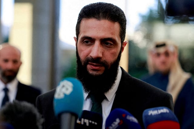 Syria's de facto leader Ahmed al-Sharaa, also known as Abu Mohammed al-Golani, speaks to the media during a meeting with Qatar's Minister of State Mohammed bin Abdulaziz Al-Khulaifi, after the ousting of Syria's Bashar al-Assad, in Damascus, Syria, December 23, 2024. REUTERS/Ammar Awad/File Photo