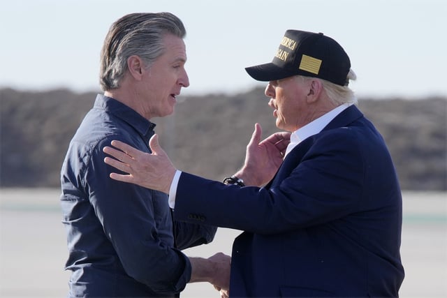 President Donald Trump talks with California Gov. Gavin Newsom after arriving on Air Force One at Los Angeles International Airport in Los Angeles, Friday, Jan. 24, 2025.