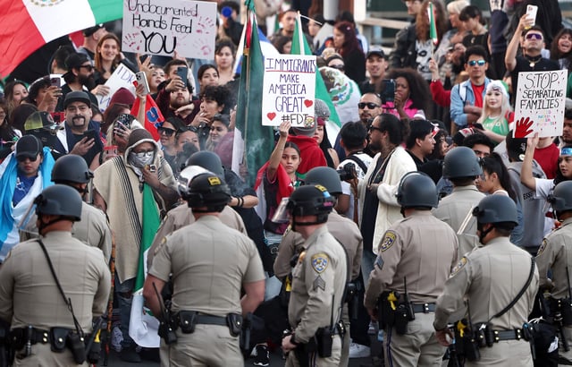 Anti-deportation demonstrators protest the Trump administration&#39;s deportations near police officers blocking an entrance to the 101 freeway on February 02, 2025 in Los Angeles, California.