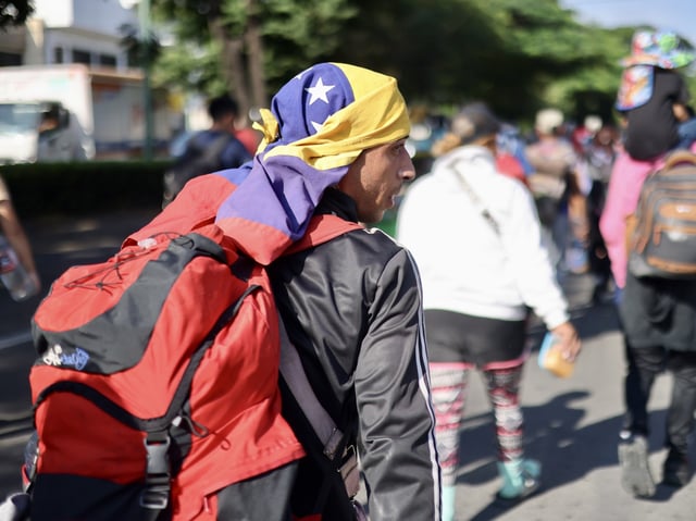 TAPACHULA, MEXICO - NOVEMBER 5: Hundreds of migrants, mostly Venezuelans, walk in a caravan on U.S. presidential election day in an attempt to reach Mexico's northern border, on November 5, 2024, in Tapachula, Mexico. A caravan of approximately 3,000 migrants set off from southern Mexico, headed toward the United States. (Photo by Jacob Garcia/Anadolu via Getty Images)