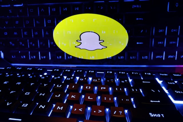 A keyboard is placed in front of a displayed Snapchat logo in this illustration taken February 21, 2023. REUTERS/Dado Ruvic/Illustration/File Photo
