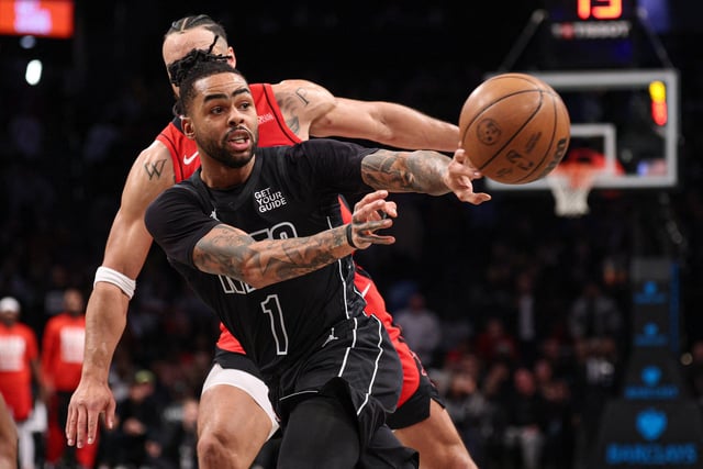 Feb 4, 2025; Brooklyn, New York, USA; Brooklyn Nets guard D'Angelo Russell (1) passes the ball in front of Houston Rockets forward Cam Whitmore (7) during the second half at Barclays Center. Mandatory Credit: Vincent Carchietta-Imagn Images