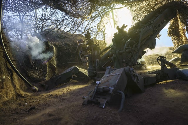 Ukrainian servicemen of the 148th artillery brigade fire a M777 howitzer towards Russian positions at the frontline on Velyka Novosilka direction, Donetsk region, Ukraine, Jan. 26, 2025. (AP Photo/Evgeniy Maloletka)