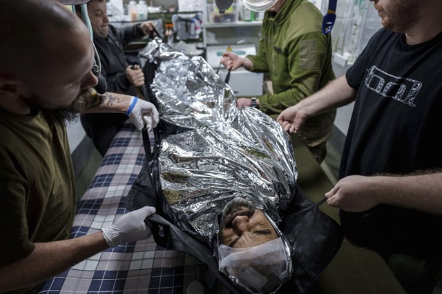 Ukrainian military medics of 59th brigade carry a wounded soldier on a stretcher in a field hospital on Pokrovsk direction, Donetsk region, Ukraine, Jan. 29, 2025. (AP Photo/Evgeniy Maloletka)