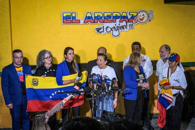 Venezuelan community leaders speak to the media as they protest against the suspension of Temporary Protected Status in Doral, Fla, on Feb. 3, 2025.