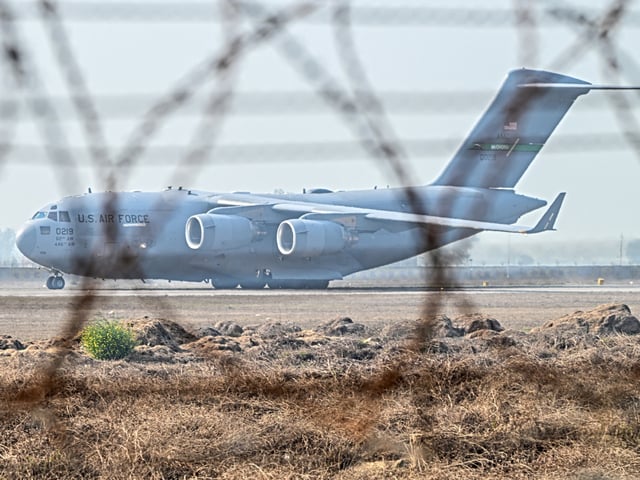 An US Air Force C-17 Globemaster III aircraft carrying undocumented Indian migrants deported by the US lands at Sri Guru Ram Dass Jee International Airport in Amritsar, Punjab, India, on Wednesday, Feb. 5, 2025. The US began deporting the first batch of undocumented Indian migrants since President Donald Trump returned to office threatening trade action against countries who didn't comply with his immigration policies. Photographer: Prakash Singh/Bloomberg