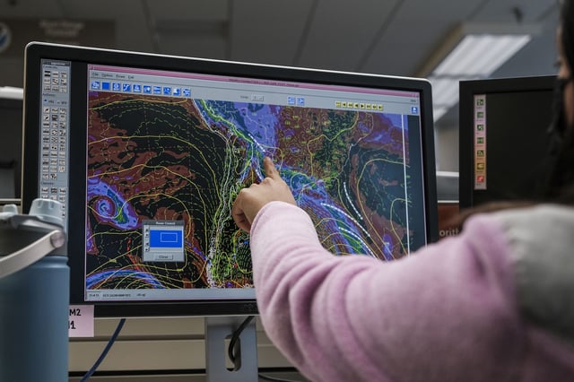 A meteorologist monitors weather activity at the National Oceanic and Atmospheric Administration Center for Weather and Climate Prediction headquarters in College Park, Maryland, in December 2024.