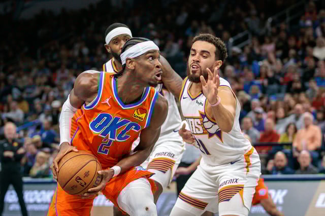 Shai Gilgeous-Alexander #2 of the Oklahoma City Thunder drives around Tyus Jones #21 of the Phoenix Suns during the third quarter of the Emirates NBA Cup game at Paycom Center on November 15, 2024 in Oklahoma City, Oklahoma.