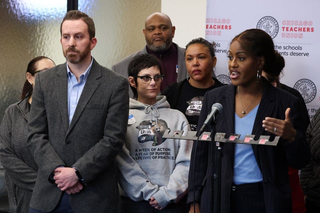 Chicago Teachers Union (CTU) Deputy General Counsel Thad Goodchild, left, listens as CTU President Stacy Davis Gates, right, talks about recommendations from the “fact-finding” process in a press conference at CTU headquarters on Feb. 5, 2025. (Terrence Antonio James/Chicago Tribune)