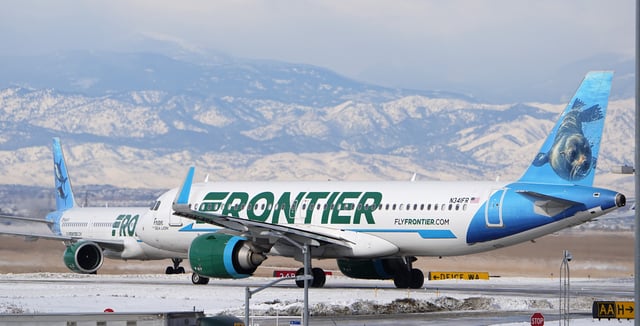 A pair of Frontier Airlines jetliners, not the airplanes involved, pass each other on a runway at Denver International Airport Tuesday, Jan. 16, 2024, in Denver.