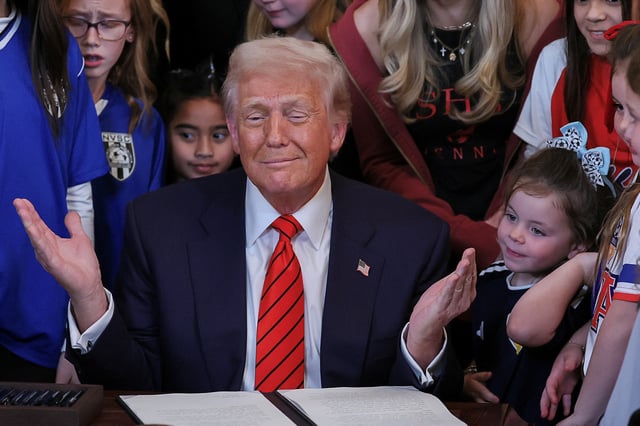 U.S. President Donald Trump gestures, as he signs an executive order banning transgender girls and women from participating in women's sports, in the East Room at the White House in Washington, U.S., February 5, 2025. REUTERS/Leah Millis/File Photo