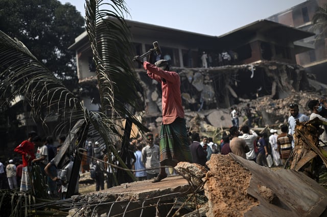 A man hammers the debris around the vandalized residence of Sheikh Mujibur Rahman, Bangladesh's former leader and the father of the country's ousted Prime Minister Sheikh Hasina, in Dhaka in Dhaka, Bangladesh, Thursday, Feb. 6, 2025. (AP Photo/Mahmud Hossain Opu)