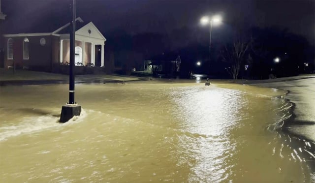 Floodwater from an overflowing creek in East Knoxville, Tenn., late Thursday.