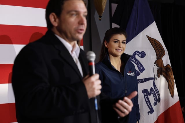 Casey DeSantis (R) listens as her husband, Republican presidential candidate Florida Gov. Ron DeSantis, speaks during a campaign event at the Chrome Horse Saloon one day before the Iowa caucuses on January 14, 2024 in Cedar Rapids, Iowa.