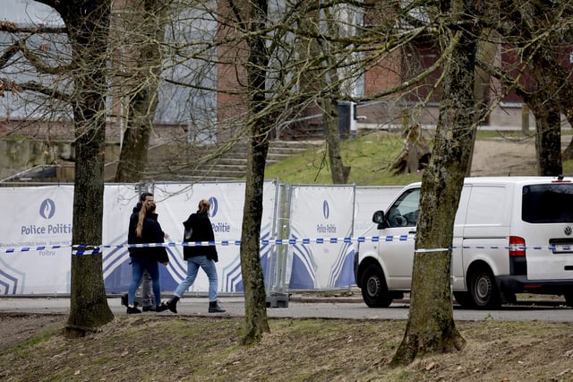 Police work in an area around an apartment complex after a shooting incident in Brussels, Friday, Feb. 7, 2025. (AP Photo/Geert Vanden Wijngaert)