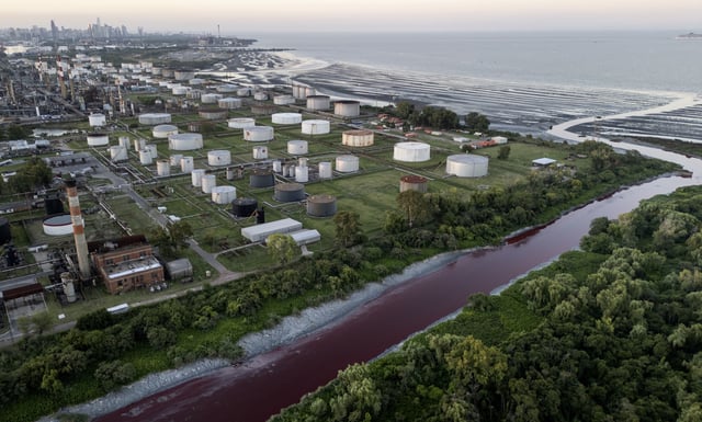 The "Sarandi" stream, dyed red due to unknown contaminants allege residents, flows into the Río de la Plata on the outskirts of Buenos Aires, Argentina, Thursday, Feb. 6, 2025. (AP Photo/Rodrigo Abd)