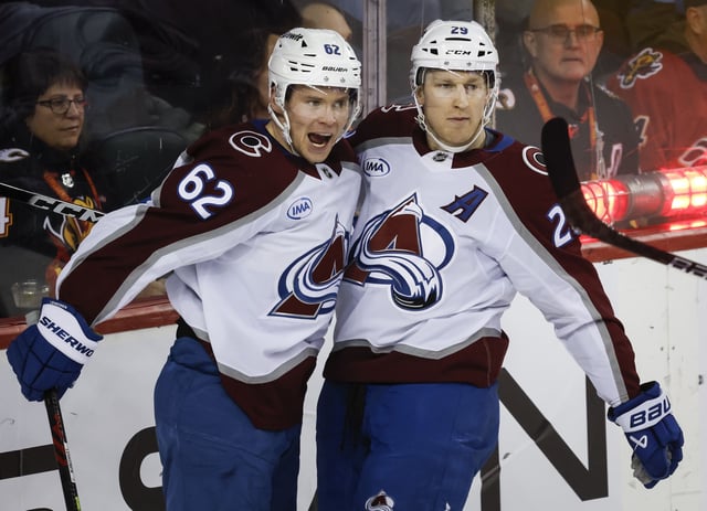 Colorado Avalanche's Artturi Lehkonen, left, celebrates his goal with teammate Nathan MacKinnon during second period NHL hockey action against the Calgary Flames in Calgary on Thursday, Feb. 6, 2025.