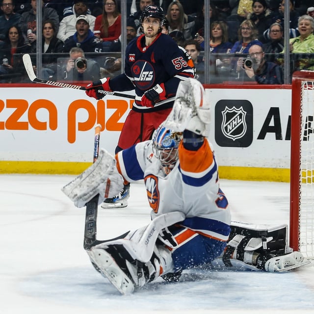 Winnipeg Jets' Mark Scheifele (55) looks on as Gabriel Vilardi's (13) shot gets past New York Islanders goaltender Ilya Sorokin (30) during second period NHL action in Winnipeg on Friday, February 7, 2025. THE CANADIAN PRESS/John Woods