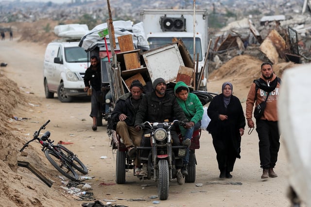 Palestinians make their way after Israeli forces withdrew from the Netzarim Corridor, allowing people to travel in both directions between southern and northern Gaza, amid a ceasefire between Israel and Hamas, near Gaza City, February 9, 2025. REUTERS/Dawoud Abu Alkas