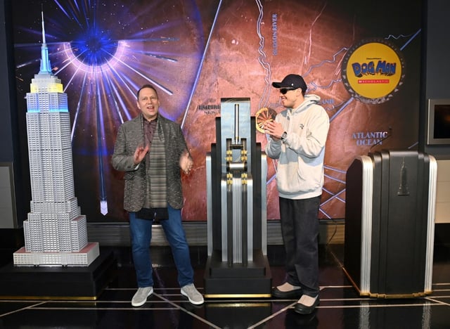 Pete Davidson (R) who voices the titular character in the animated movie 'Dog Man,'  visits The Empire State Building with Dav Pilkey to celebrate the film's premier