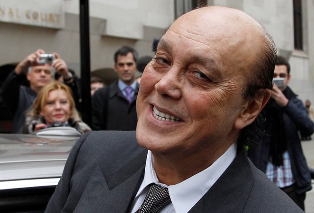 Turkish-Cypriot tycoon Asil Nadir smiles as he leaves the Old Bailey court in this photograph taken October 15, 2010.  REUTERS/Stefan Wermuth/File Photo