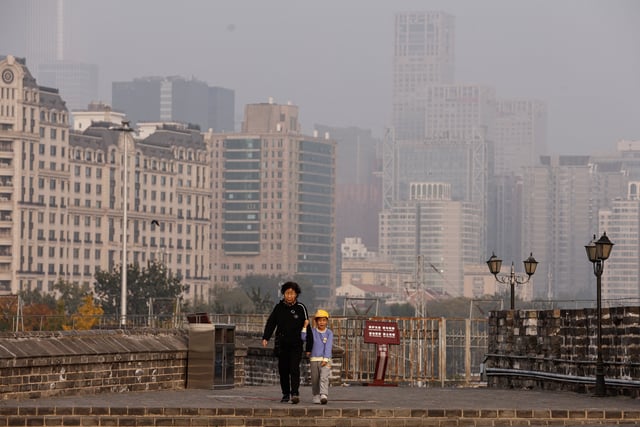 People walk at the Ming Dynasty City Wall Relics Park, as Beijing issues orange alert for heavy air pollution, in Beijing, China October 31, 2023. REUTERS/Tingshu Wang/File Photo