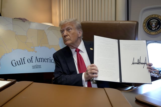 President Donald Trump holds up a signed proclamation declaring Feb. 9 Gulf of America Day, aboard Air Force One as he travels from West Palm Beach, Fla. to New Orleans, Sunday, Feb. 9, 2025.