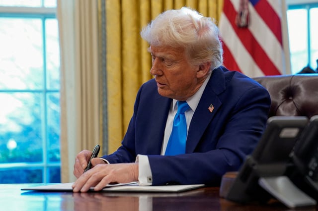 President Donald Trump signs a document in the Oval Office at the White House in Washington, D.C. on Feb. 4, 2025.