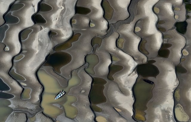 Stranded boats over the sandbanks exposed due to drought at the Solimoes River, one of the largest tributaries of the Amazon River, near Manacapuru, Amazonas state, Brazil September 30, 2024.