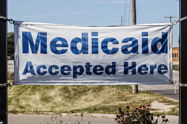 Stock photo shows Medicaid Accepted Here sign.
