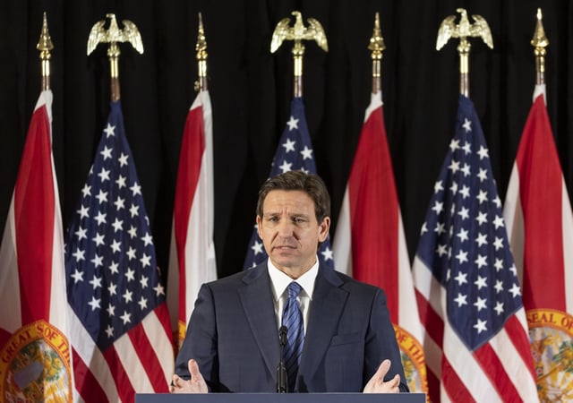 Florida Governor Ron DeSantis answers questions from the media during a press conference at Christopher Columbus High School on Monday, March 27, 2023, in Miami, Fla. The press conference was held to announce DeSantis&#39;s signing of a private school voucher expansion, HB1, which allows more Florida school children become eligible for taxpayer-funded school vouchers.(Matias J. Ocner/Miami Herald via AP)
