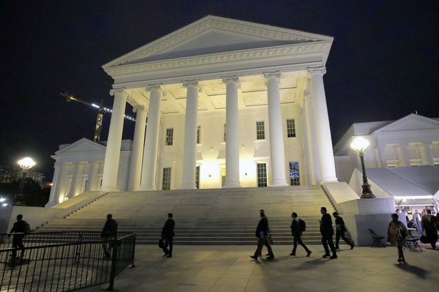 House of Delegates members walk past the south portico at the Virginia State Capitol in Richmond in 2020. 