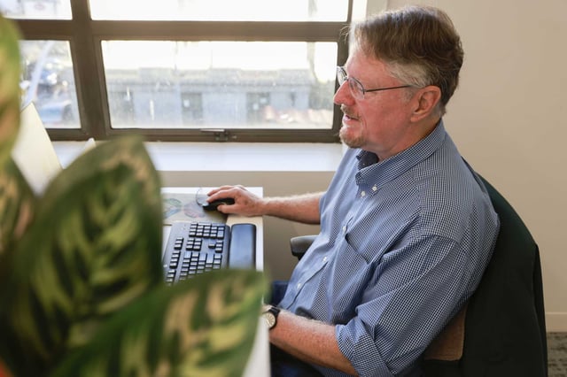 Kevin Fagan works at his desk in the Chronicle newsroom in January. 