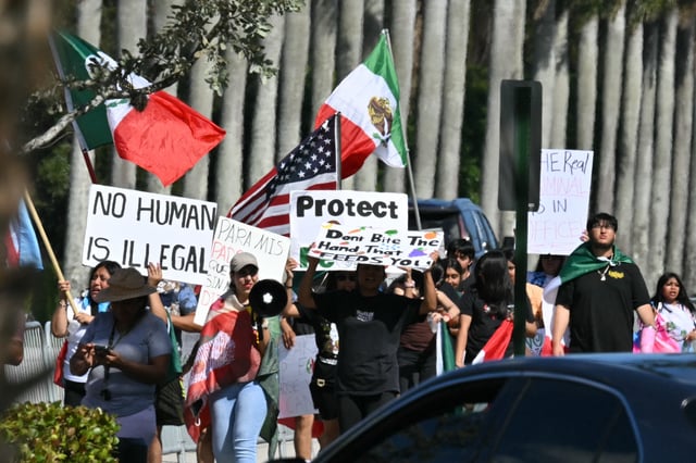 Demonstrators protest against mass deportations and the immigration policies of President Donald Trump, in West Palm Beach, Florida, on February 8, 2025.
